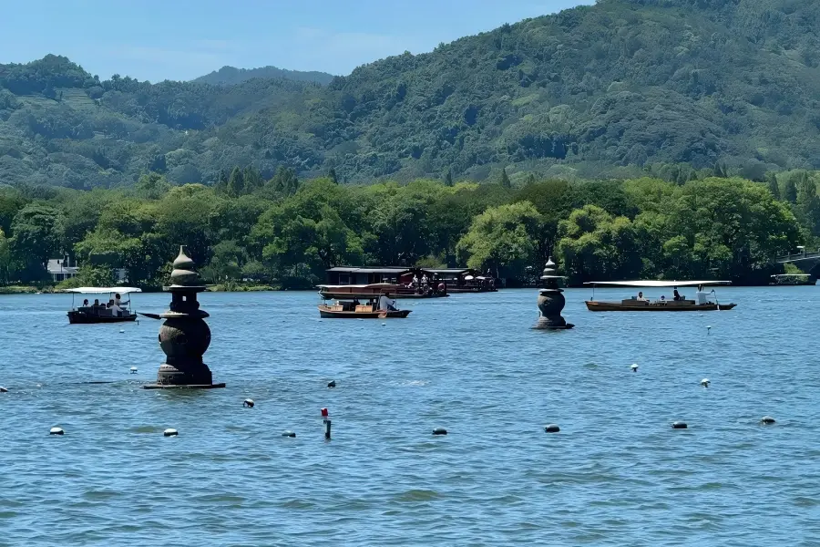 West Lake in Hangzhou showing peaceful lake view with surrounding hills and pavilions