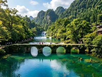Ancient Seven?Arch Bridge over emerald water, lush forest and waterfall in Libo Guizhou