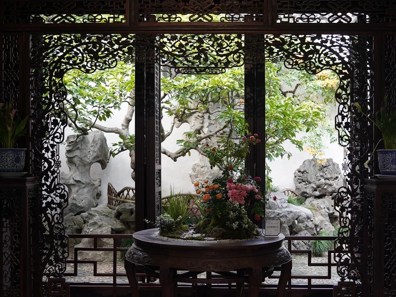 Ornate wooden lattice framing rock?garden courtyard in Suzhou