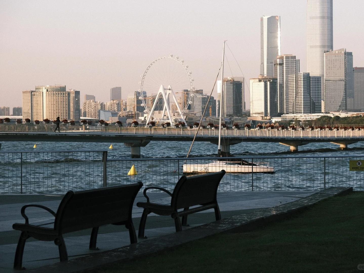 Lakeside park with Ferris wheel and Suzhou modern city skyline