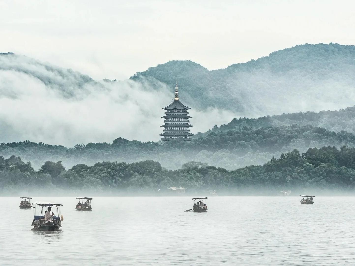 Boats on misty West Lake with Leifeng Pagoda
