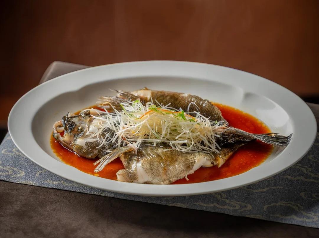 Classic Chinese steamed grouper dish on plate