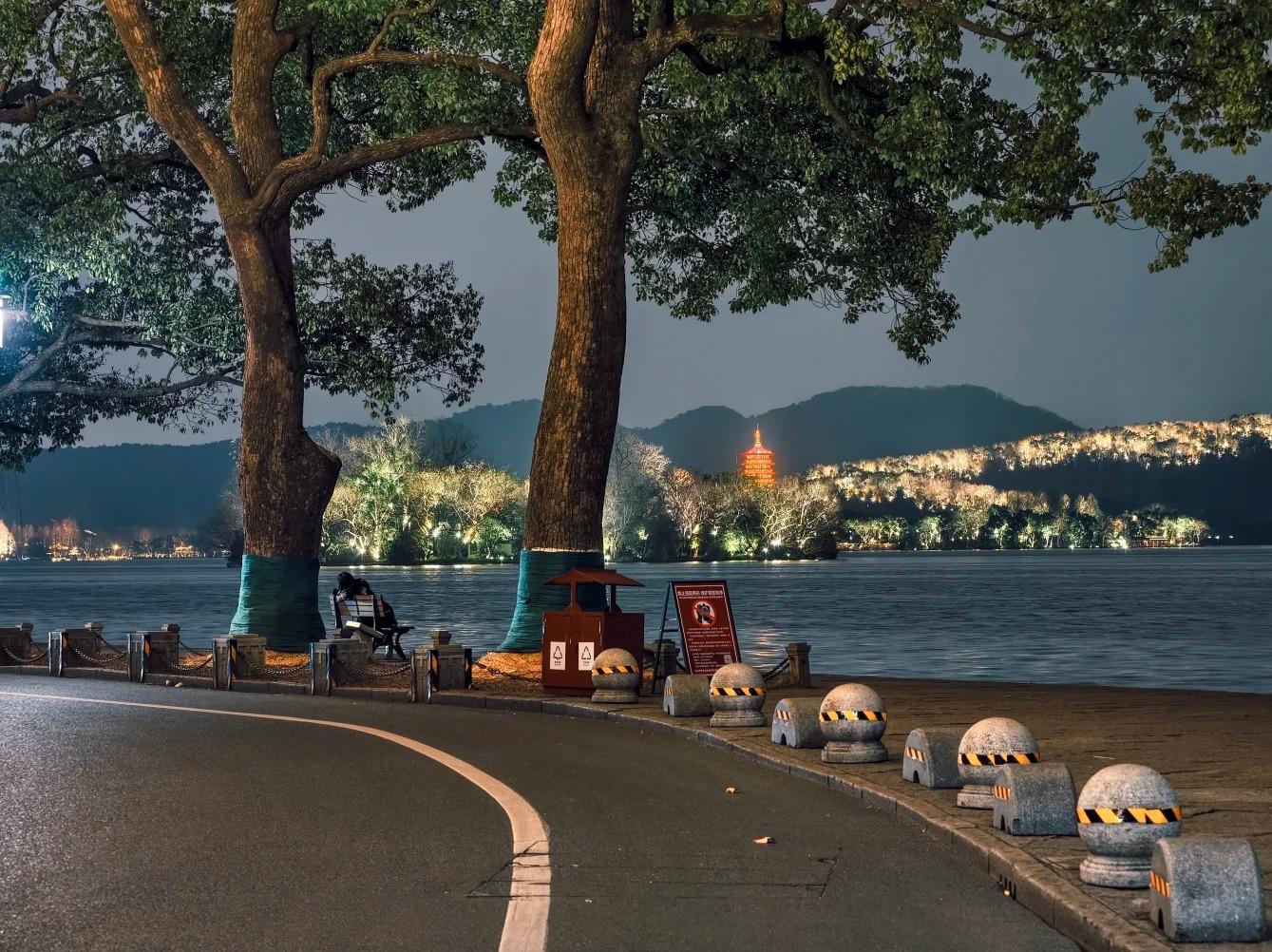 West Lake waterfront night scenery overlooking lit Leifeng Pagoda
