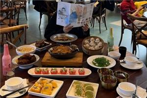 Full spread of classic Hangzhou cuisine, roast duck, dumplings, local snacks and side dishes at a city restaurant
