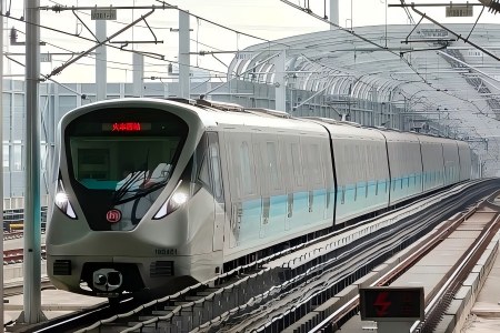 Modern Hangzhou metro train traveling on outdoor elevated railway tracks
