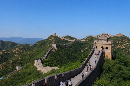 Daytime view of the Badaling Great Wall winding through green mountains in Beijing