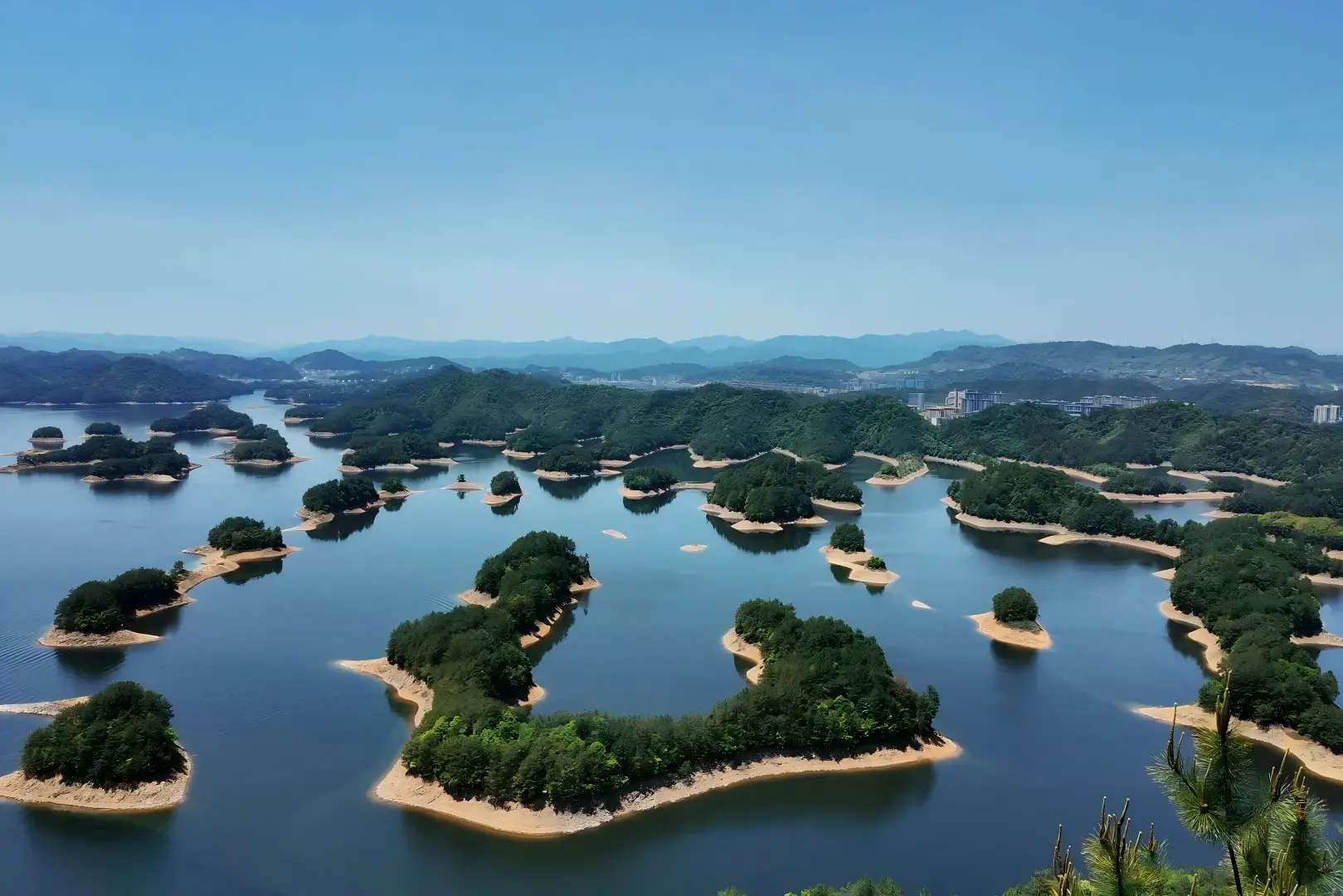 Aerial view of countless green forested islands scattered across blue Qiandao Lake, Zhejiang