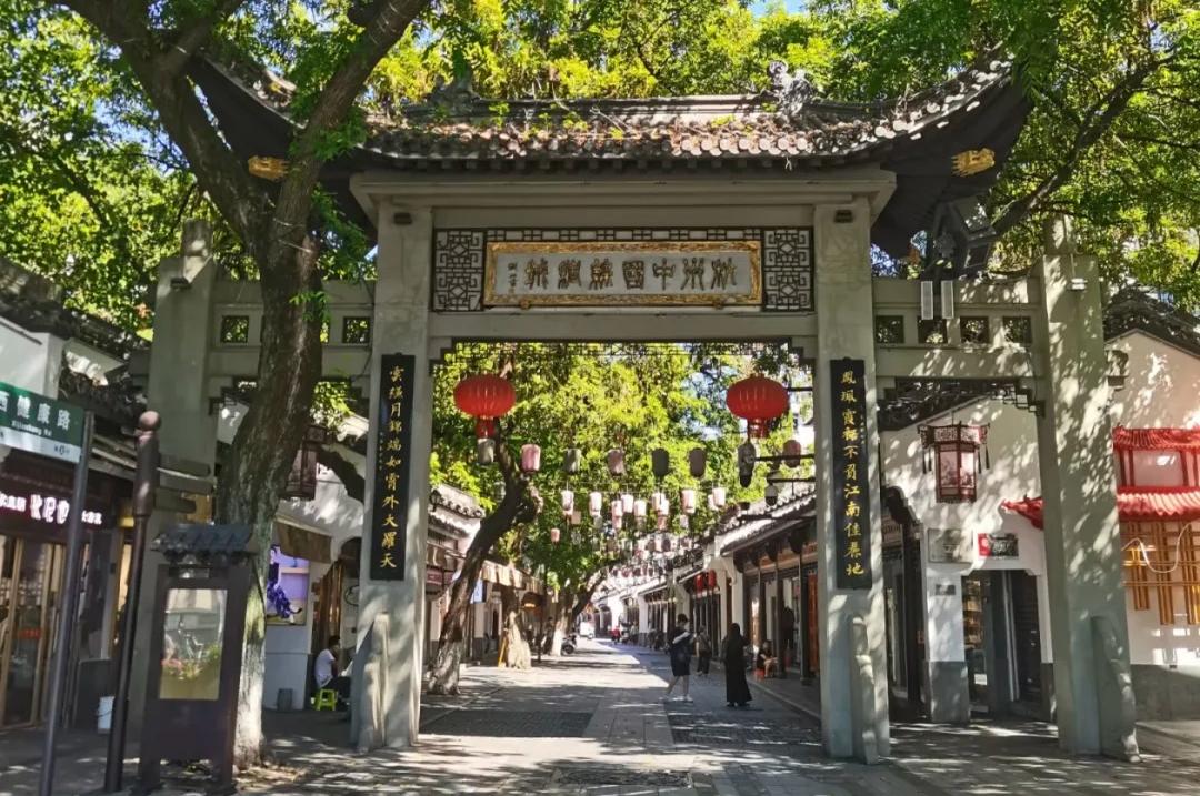 Stone arch gate of China Silk City Hangzhou, ancient Jiangnan street decorated with red lanterns