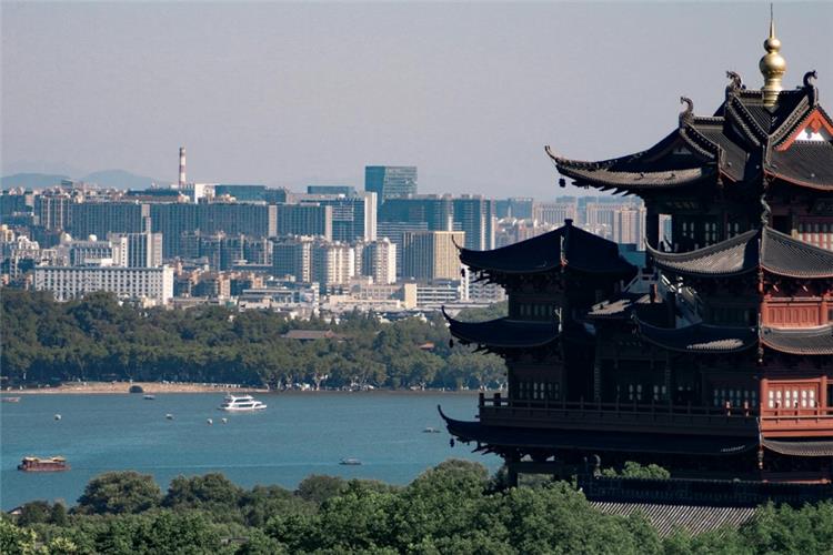 Panoramic View of West Lake from Chenghuang Pavilion Ancient Chenghuang Pavilion overlooking West Lake, cruise boats and Hangzhou city skyline