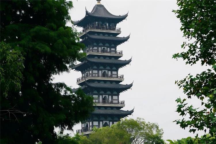 Well-preserved Wuzhen ancient water town along the Grand Canal, dotted with black-awning rowing boats drifting on calm river, blue stone alleys and time-honored silk, wine and indigo dyeing folk craft workshops