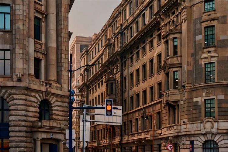 Nanjing Road in Shanghai showing bustling pedestrian shopping street with historic European buildings and glowing neon signs