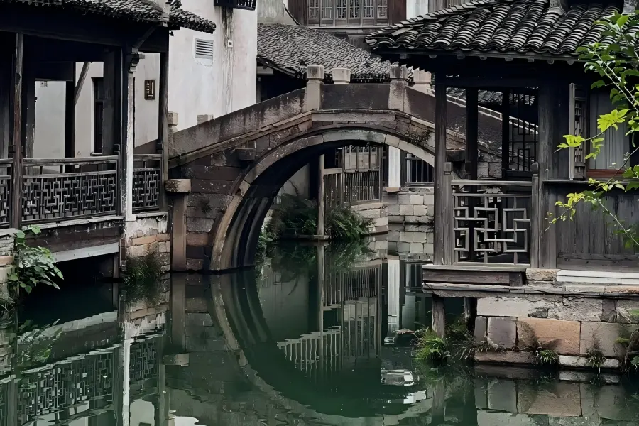 Wuzhen World Internet Conference Water Town Wuzhen Water Town in Jiaxing showing well-preserved classic Jiangnan canal town with black-tiled waterside houses, stone arch bridges, black-awning rowing boats and lantern-lit ancient alley scenery