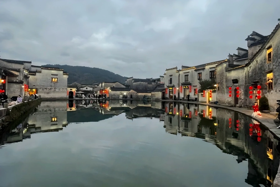 Hongcun Ancient Village in Huangshan showing world-famous Hui-style ox-shaped ancient village with Moon Marsh, South Lake, mirrored white-walled black-tile houses, ancient courtyards and ink-wash rural scenery hailed as 
