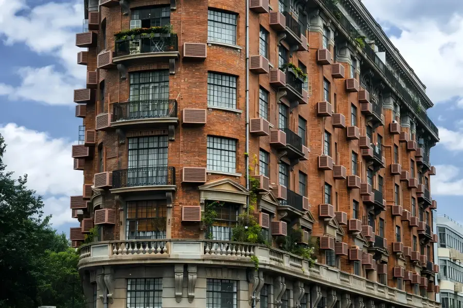 Wukang Mansion in Shanghai showcasing the iconic wedge-shaped historic apartment building at the street crossing
