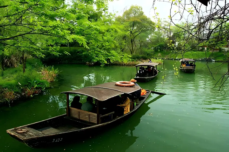 Reed Canal Scenery of Hangzhou Xixi Wetland Xixi National Wetland Park in Hangzhou featuring crisscross waterways, reed marshes and ancient stone arch bridges hidden in lush green foliage
