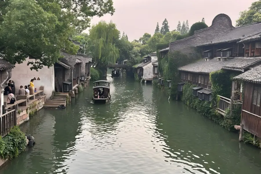 Lantern-lit Night Canal of Tongli Water Town Twilight scenery of Tongli Ancient Canal lined with red lantern reflections on calm water, bluestone alleys and ancient waterfront folk dwellings of Ming and Qing styles