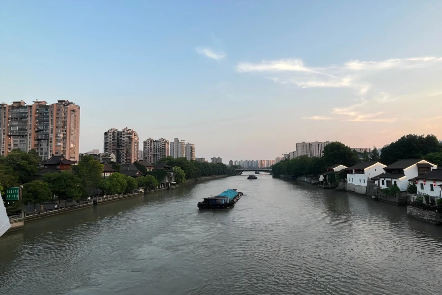 Beijing-Hangzhou Grand Canal in Hangzhou showing ancient waterway, cruise boats and riverside historic scenery