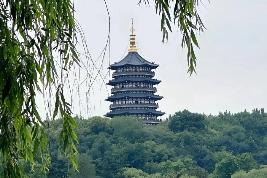 Leifeng Pagoda in Hangzhou showing golden ancient pagoda overlooking West Lake under sunset glow