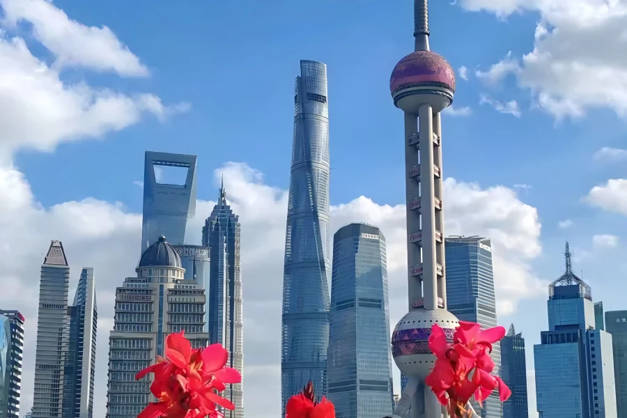 North Bund riverside promenade overlooking Lujiazui skyscrapers and Huangpu River, featuring riverside lighthouse and waterfront green space