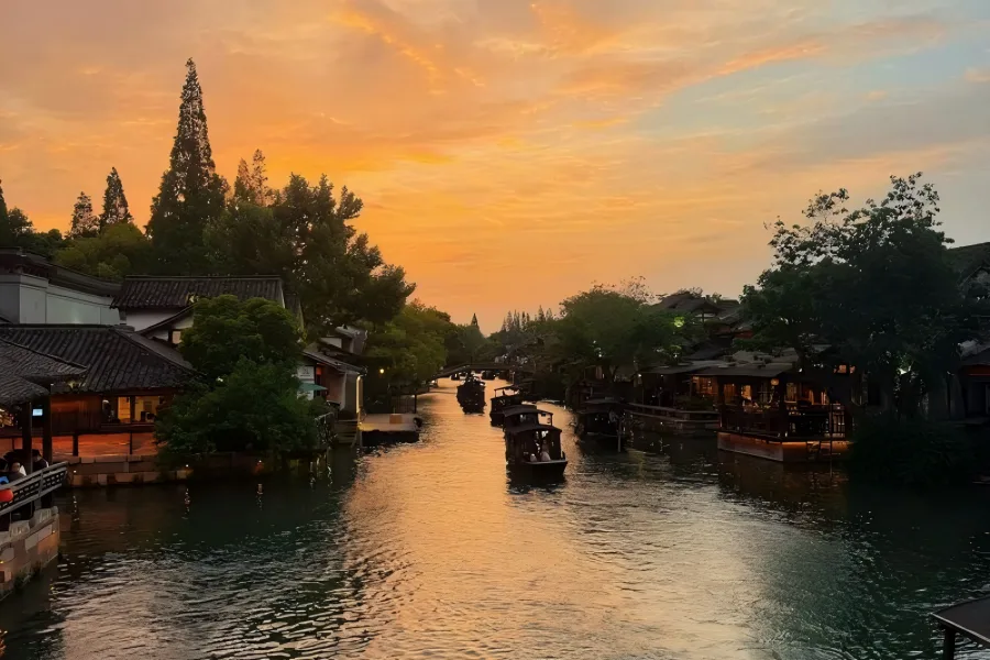 Wuzhen Water Town in Jiaxing showing classic Jiangnan canals, stone arch bridges and black-tiled waterside houses