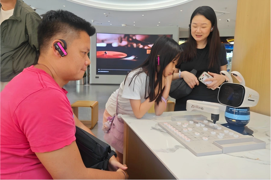 Alibaba Qinchengli Experience Center in Hangzhou showing visitors playing chess with intelligent AI robot
