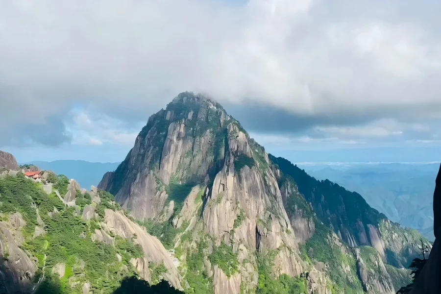 Magnificent natural landscape of Huangshan covered with mist, weird rock formations and green pine trees