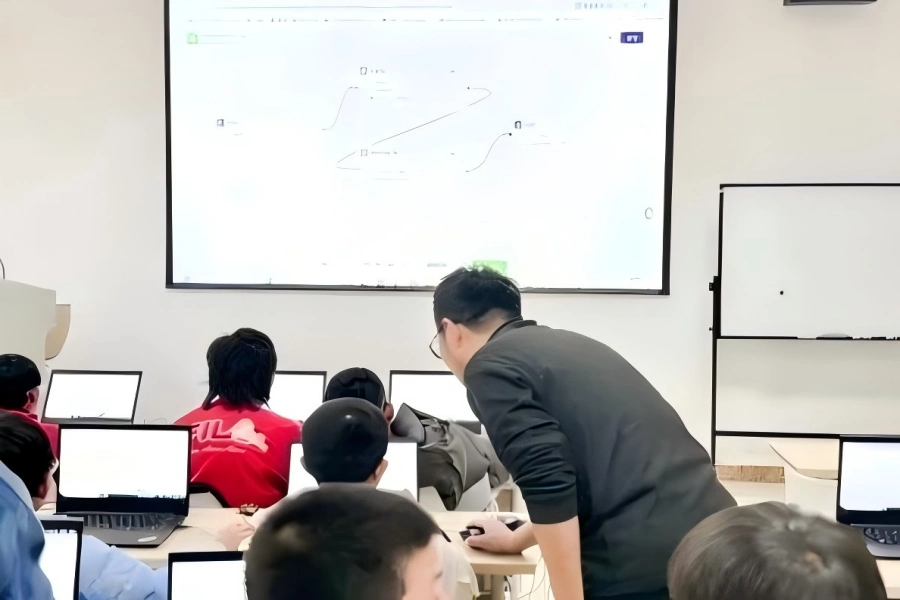 Kids learning to develop AI agent with laptops