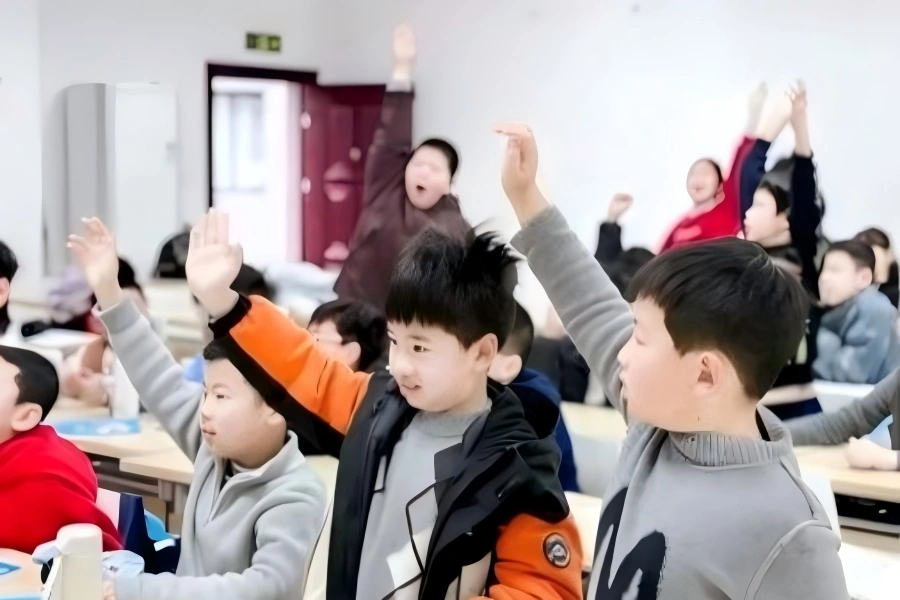 Young students raising hands actively during interactive study tour class