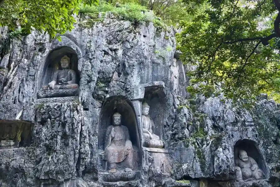 Lingyin Temple Hangzhou Ancient Zen Buddhist temple hidden among green mountains beside West Lake, home to Feilai Peak cliff Buddhist carvings and serene sacred atmosphere