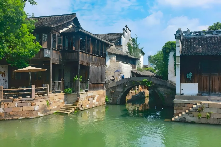 Wuzhen Dongzha Scenic Area in Zhejiang showing authentic Jiangnan water?town scenery with canal houses, stone bridges and wooden rowing boats