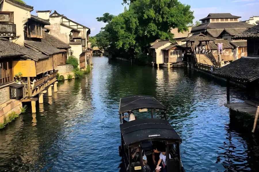 Wuzhen Water Town in Zhejiang showing classic Jiangnan canal scenery, stone arch bridges and waterside ancient dwellings