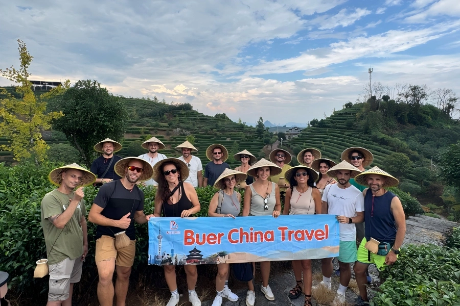 Longji Rice Terraces in Longsheng showing vast agricultural landscape, golden rice paddies winding along mountain ridges under soft daylight
