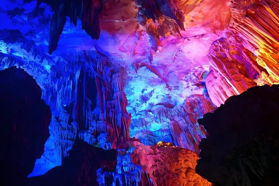 Reed Flute Cave in Guilin showing the famous State?Guest Cave, magical underground scenery with multi?colored lighting highlighting unique rock landscapes