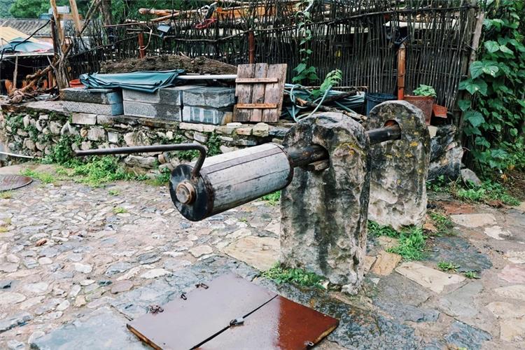 Historic stone?framed old well with manual wooden windlass in Cuanxia ancient village