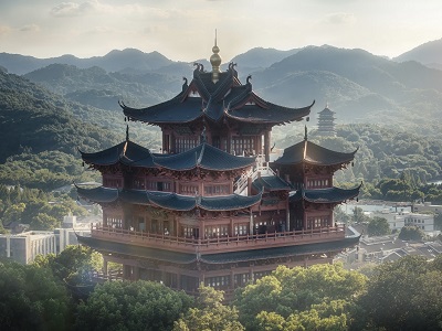 Stunning sunset scenery of traditional Chenghuang Pavilion surrounded by lush forest and rolling mountains