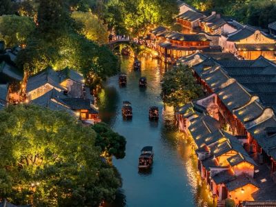 Beautiful Wuzhen Xizha Night Canal Scenery with Lit Ancient Water Town Buildings