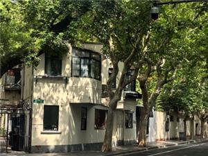 Quiet street view of vintage historic villa shaded by lush plane trees on Shanghai Wukang Road