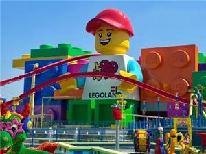 Bright exterior view of Shanghai Legoland with giant Lego figure landmark