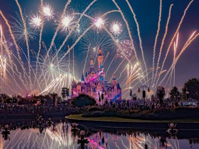 Night view of Enchanted Storybook Castle with gorgeous fireworks reflection on lake at Shanghai Disneyland