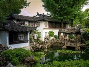 Traditional Suzhou Lingering Garden view with white wall, black tile, pond, rockery and ancient pavilion