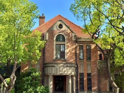 Vintage red brick villa of Suzhou No.1 Silk Factory surrounded by green trees