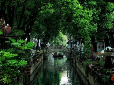 Scenery of ancient Chinese garden in Tongli Water Town, surrounded by lush green trees
