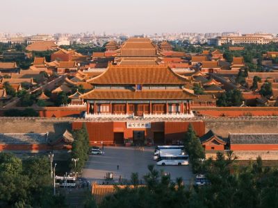 Overlooking the grand ancient Forbidden City complex with golden glazed tile roofs and red palace walls
