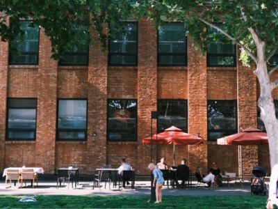 Retro red brick factory building with outdoor café seating at Beijing 798 Art Zone