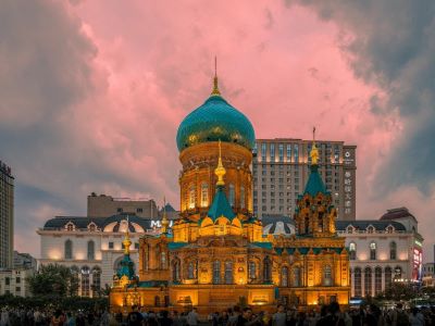 Ornate Saint Sophia Cathedral of Harbin under soft pink sky, classic Russian-style architecture