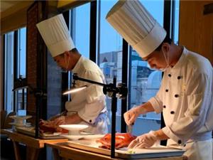 The chef in a Beijing restaurant cuts Beijing roast duck in front of customers