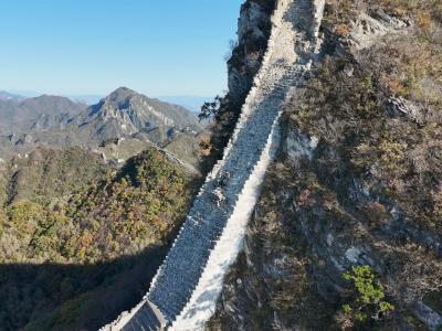 Outdoor enthusiasts climb steep slopes of the Jiankou Great Wall