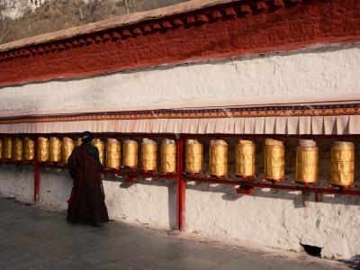 Tibetan Pilgrim Walking Along Golden Prayer Wheels Wall Lhasa Traditional Tibetan Culture Tour