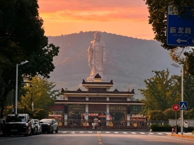 Gate of Lingshan Scenic Area with grand Lingshan Giant Buddha under sunset sky in Wuxi