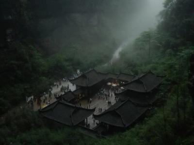Misty Wulong Scenic Area in Chongqing featuring traditional Chinese buildingslush green mountains